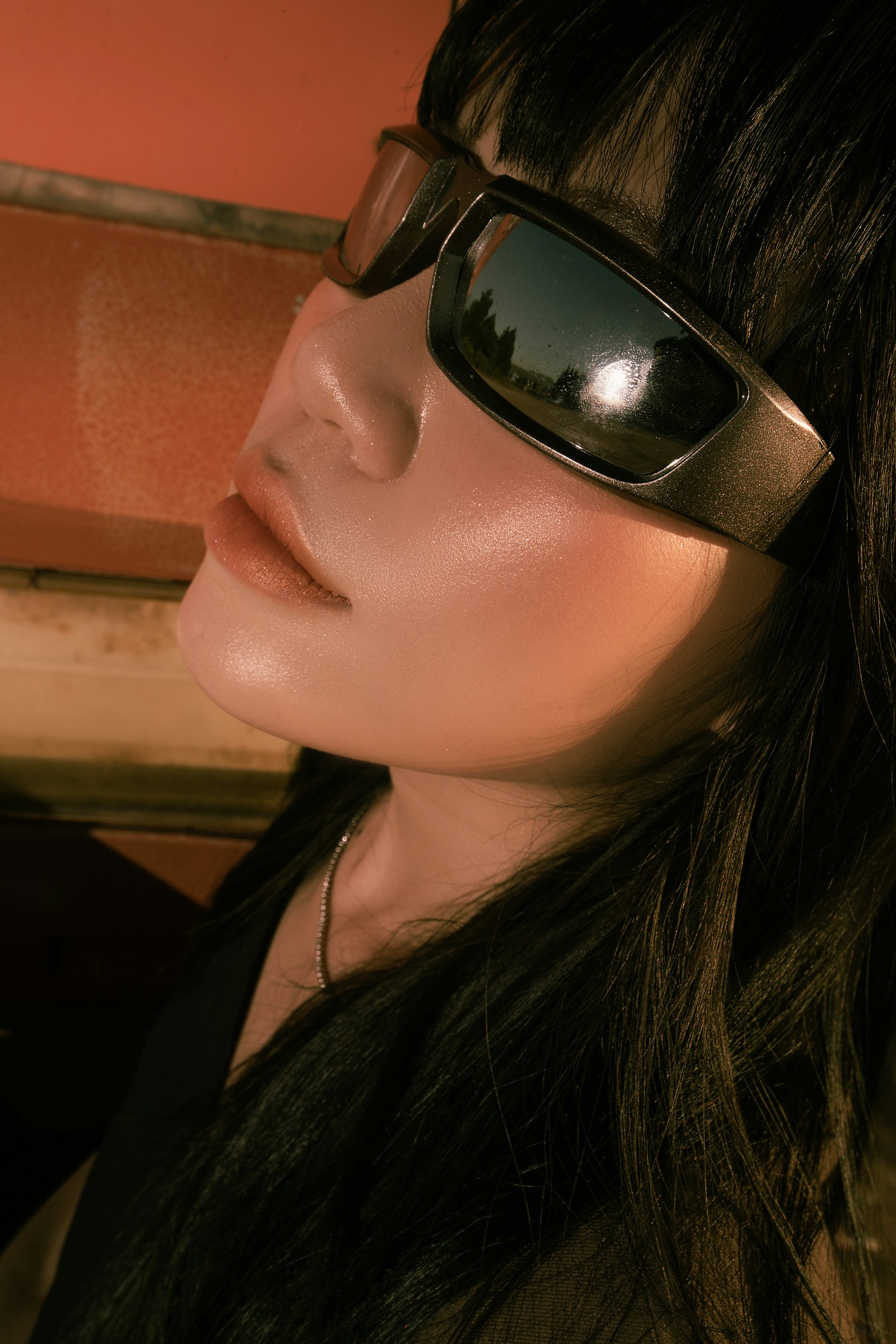 Editorial portrait reflected in angular sunglasses